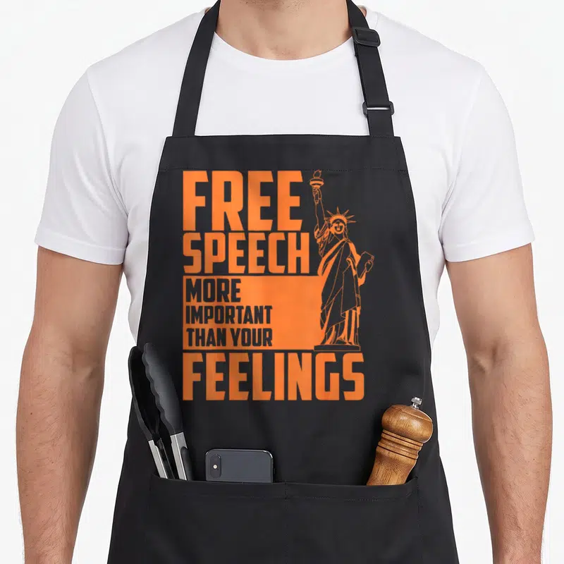 Free journalist apron - Orange Free Speech More Important Than Your Feelings text next to Statue of Liberty outline — shown on a black cotton canvas apron against a white background