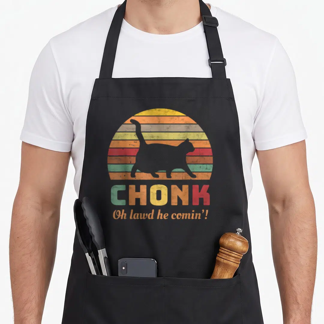 Scale cat apron - Grey cat silhouette over striped sunset with CHONK text — shown on a black cotton canvas apron against a white background