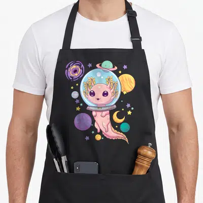 Axolotl anime cooking apron - Pink axolotl in space helmet surrounded by planets and stars in cartoon style — shown on a black cotton canvas apron against a white background