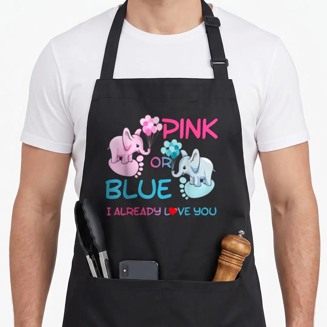Gender family aprons - Pink and blue elephants holding balloons with stacked PINK OR BLUE text and I ALREADY LOVE YOU — shown on a black cotton canvas apron against a white background