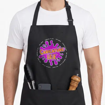 Caricature splash aprons - Purple ink splash with orange CARICATURE iNK text and circular white phrases — shown on a black cotton canvas apron against a white background