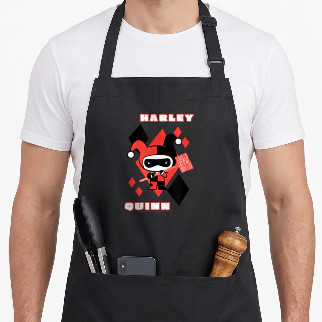 Chibi vehicle apron - Cartoon Harley Quinn holding hammer between red and black diamonds with HARLEY QUINN text — shown on a black cotton canvas apron against a white background