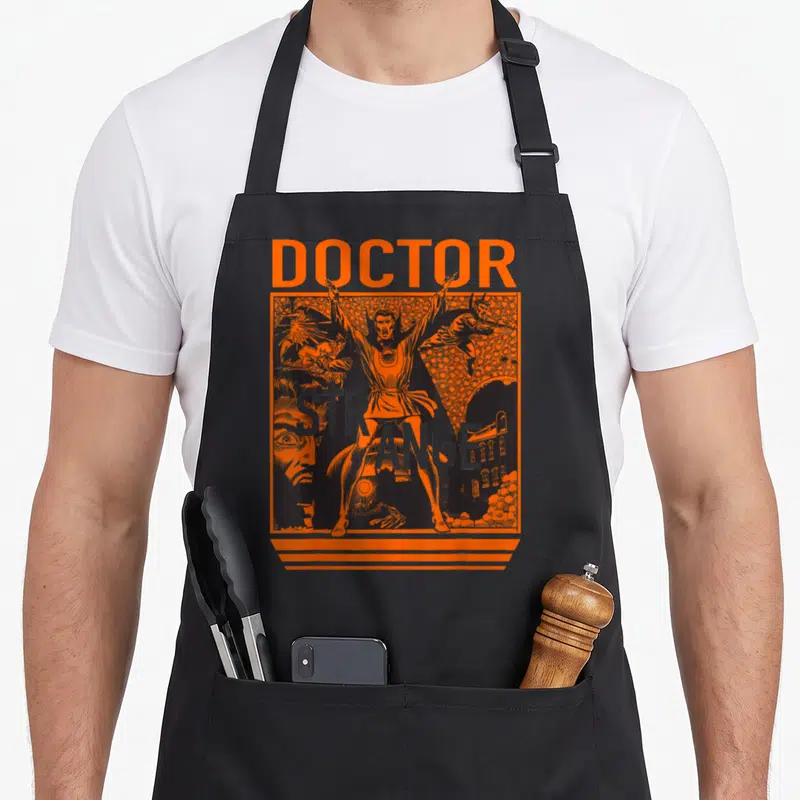 Funny strange doctor apron - Orange and black line art of Doctor Strange with text DOCTOR STRANGE and surreal figures — shown on a black cotton canvas apron against a white background