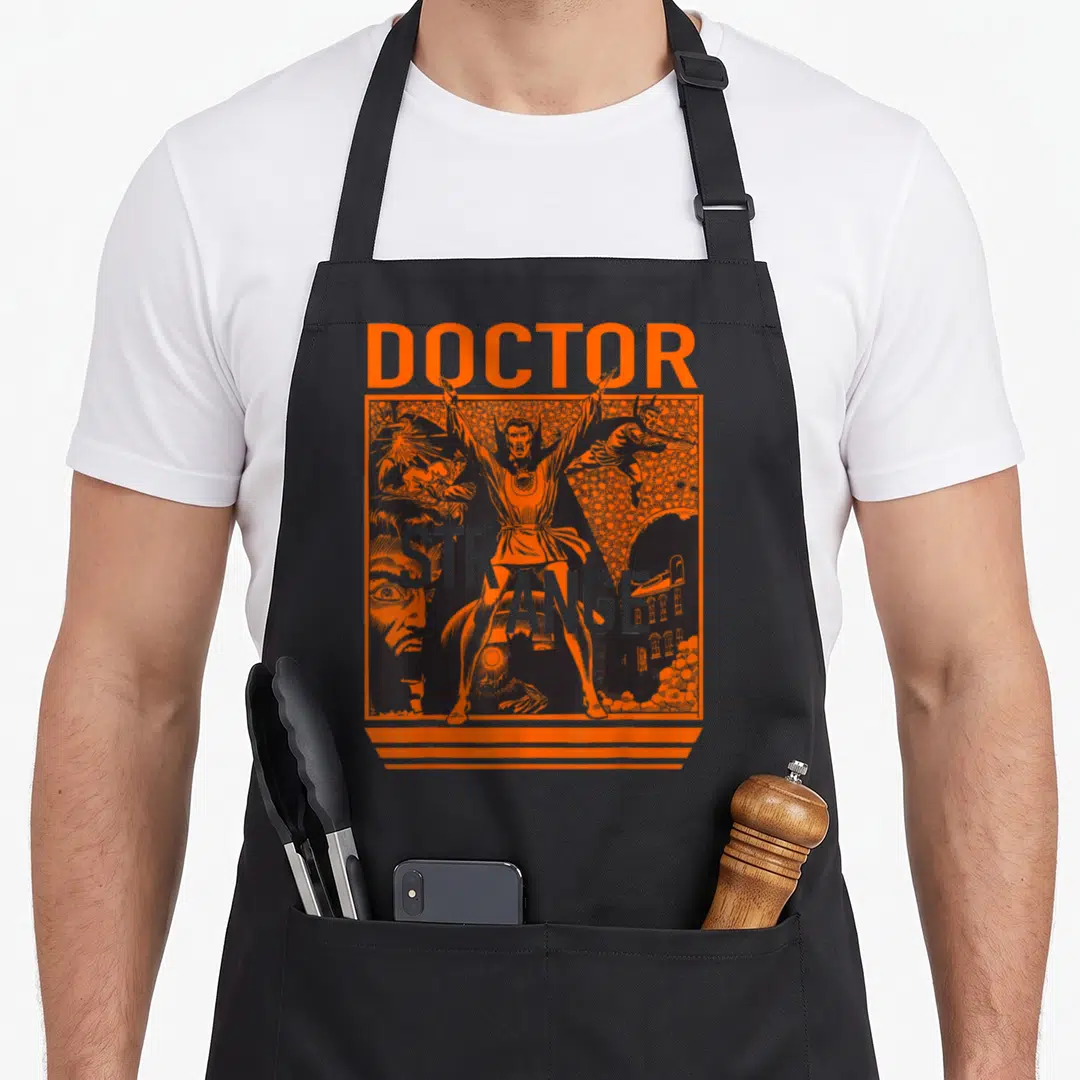 Funny strange doctor apron - Orange and black line art of Doctor Strange with text DOCTOR STRANGE and surreal figures — shown on a black cotton canvas apron against a white background