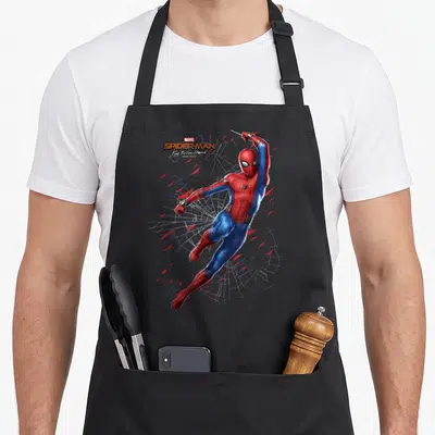 Far boy spider apron - Spider-Man swinging in red and blue suit surrounded by white webbing and red shards — shown on a black cotton canvas apron against a white background