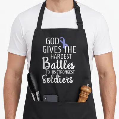 Stomach ribbon apron - White stacked text and purple awareness ribbon on grey background — shown on a black cotton canvas apron against a white background