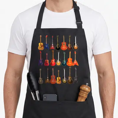 Rock musical apron - Twenty cartoon guitars in brown, red, blue, black, and orange arranged in three rows — shown on a black cotton canvas apron against a white background