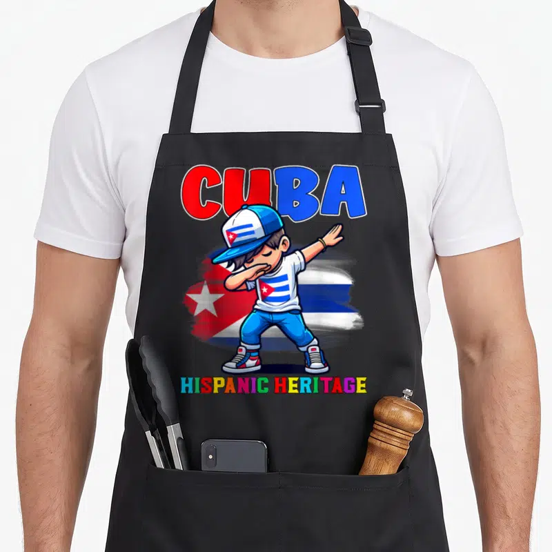 Dabbing hispanic aprons - Cartoon boy dabbing in front of Cuban flag with CUBA and HISPANIC HERITAGE text — shown on a black cotton canvas apron against a white background