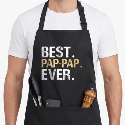 Granddaughter papa from grandchildren accessories stuff apron - Stacked white and gold text reading BEST PAP-PAP EVER — shown on a black cotton canvas apron against a white background