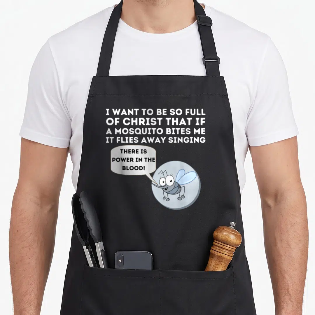 Mosquito christian apron - Cartoon mosquito in blue circle with speech bubble and white text about being full of Christ — shown on a black cotton canvas apron against a white background