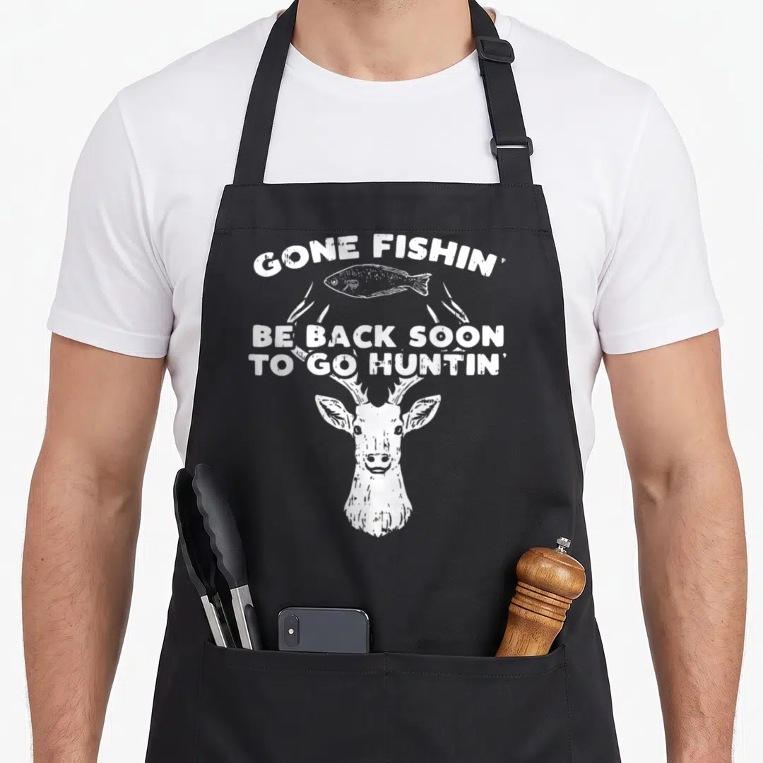 Boredkoalas fishing aprons - White distressed deer head with antlers framing a fish and text reading GONE FISHIN — shown on a black cotton canvas apron against a white background