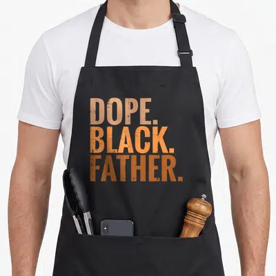 Dope african father day apron - Stacked tan orange and brown text reading DOPE BLACK FATHER — shown on a black cotton canvas apron against a white background