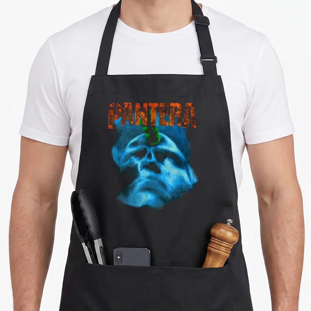 Pantera beyond apron - Arched orange PANTERA text above a blue skull with a green horn on black fabric — shown on a black cotton canvas apron against a white background