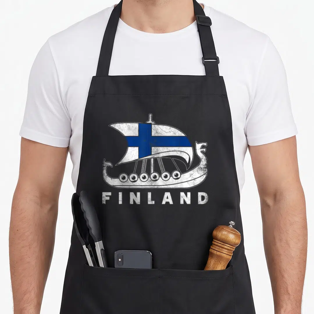 Finnish viking apron - Distressed white viking ship with blue cross sail and FINLAND text below — shown on a black cotton canvas apron against a white background