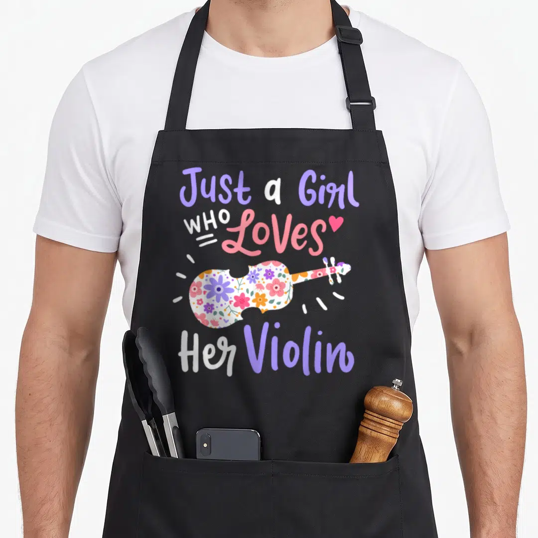 Violinist violin apron - Cartoon violin with purple and pink floral pattern and text Just a Girl Who Loves Her Violin — shown on a black cotton canvas apron against a white background