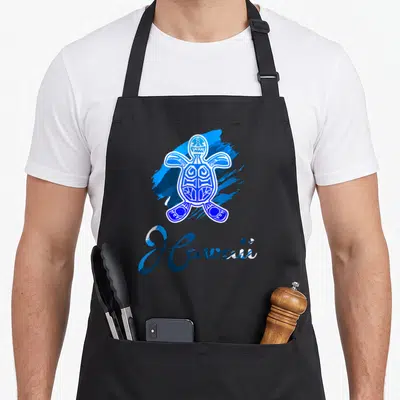 Blue tribal hawaiian apron - Blue and white cartoon tribal sea turtle over paint splash with Hawaii script text — shown on a black cotton canvas apron against a white background