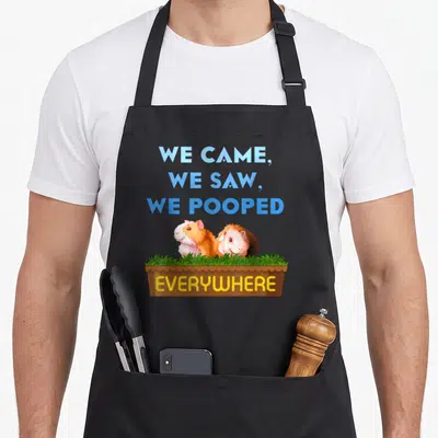 Came pet apron - Two guinea pigs in brown box with blue text and yellow everywhere label — shown on a black cotton canvas apron against a white background