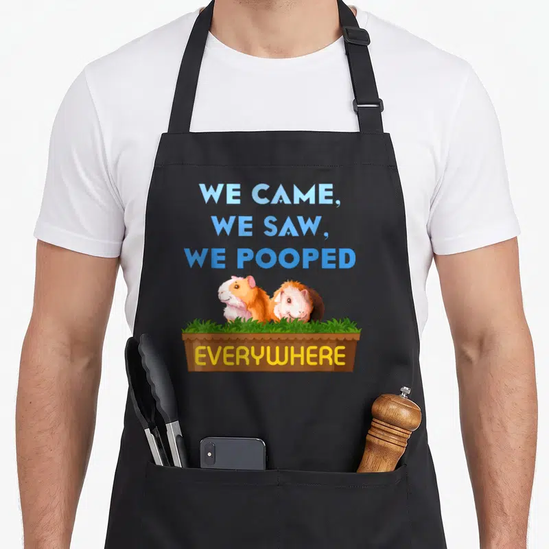 Came pet apron - Two guinea pigs in brown box with blue text and yellow everywhere label — shown on a black cotton canvas apron against a white background