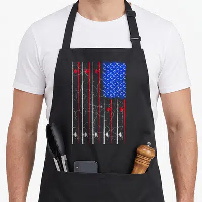 Rod american flag apron - Fishing rods in red and white stripes with blue hook rectangle, distressed style — shown on a black cotton canvas apron against a white background