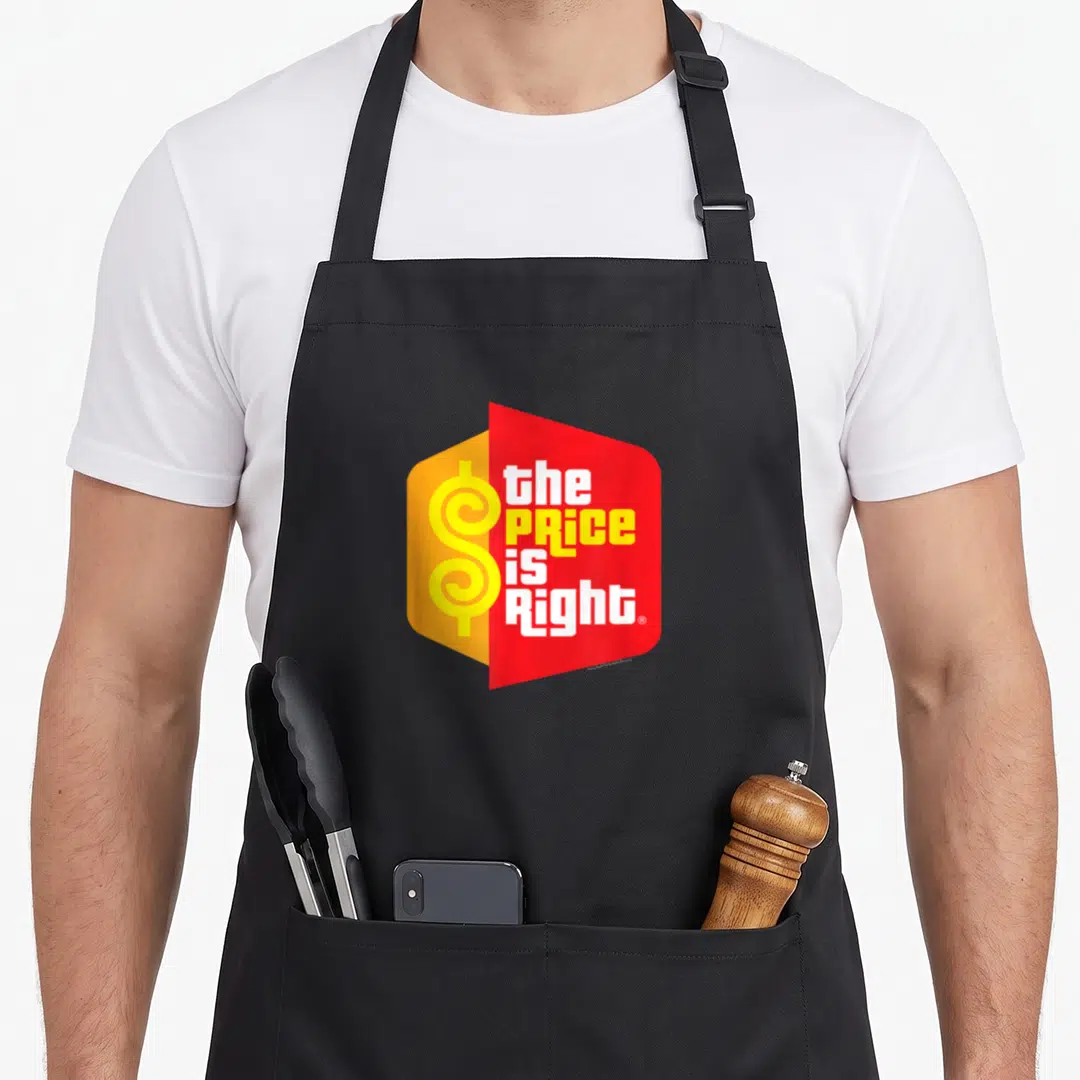 Price logo officially apron - stacked text the PRICE is Right with yellow dollar sign on red and orange shapes — shown on a black cotton canvas apron against a white background