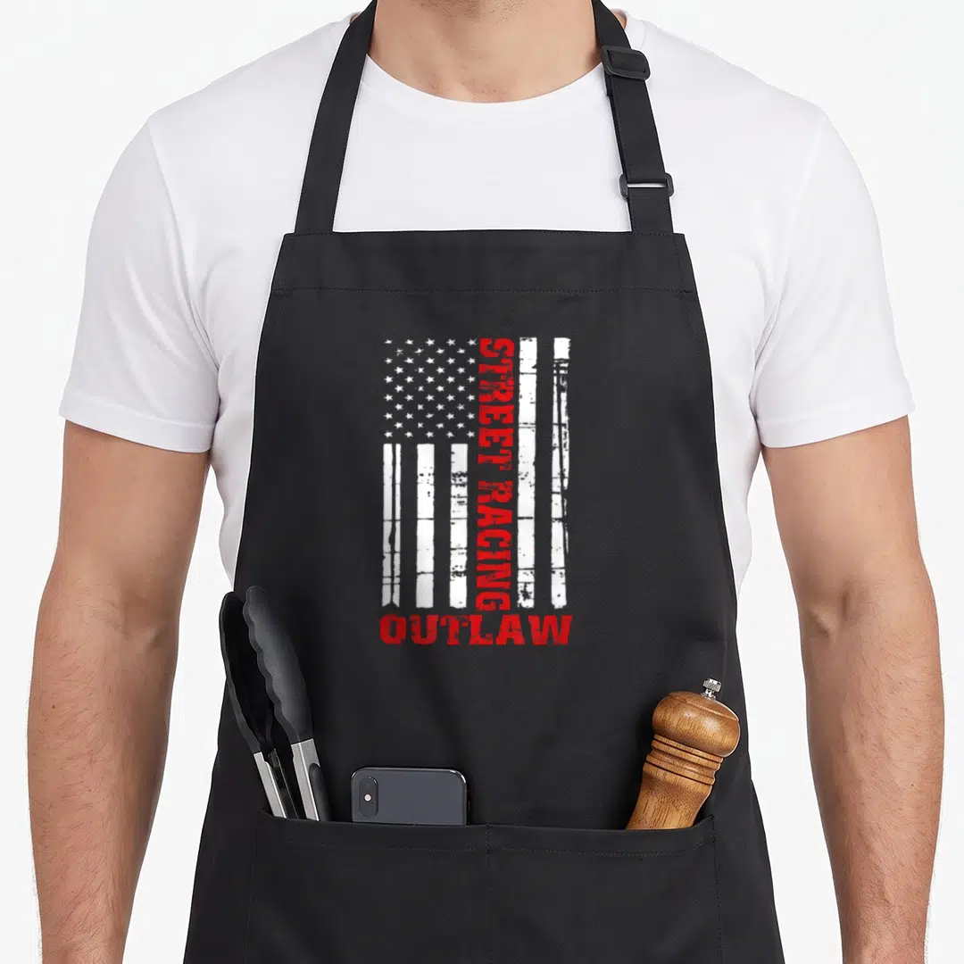 Street american flag apron - Distressed USA flag with vertical STREET RACING text and horizontal OUTLAW in red and white — shown on a black cotton canvas apron against a white background