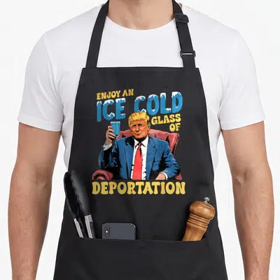 Enjoy old ice apron - Trump cartoon holding glass with Enjoy An Ice Cold Glass Of Deportation text in blue and yellow — shown on a black cotton canvas apron against a white background