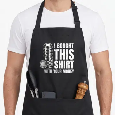 Poker money apron - Stack of black and white poker chips next to distressed text I bought this shirt with your money — shown on a black cotton canvas apron against a white background
