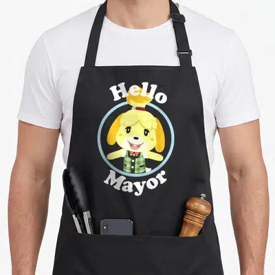 Isabelle hello apron - Yellow cartoon dog in blue circle with white Hello Mayor text — shown on a black cotton canvas apron against a white background