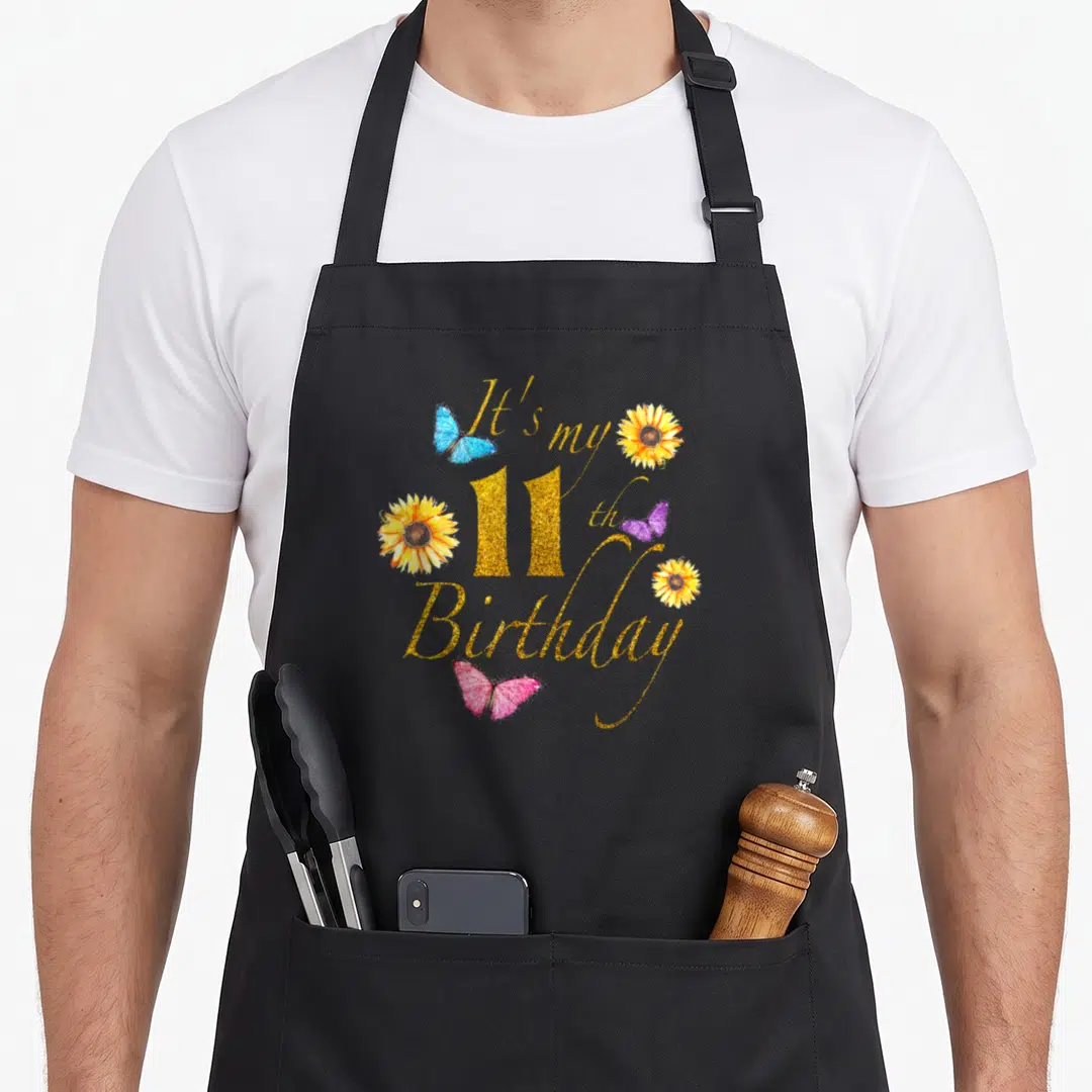 Sunflower butterfly aprons - Gold glitter text It's my 11th Birthday with three sunflowers and three butterflies — shown on a black cotton canvas apron against a white background