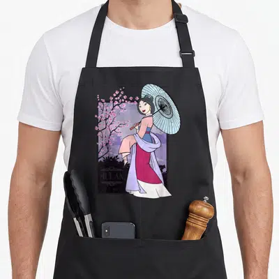 Honor cherry print apron - Mulan holding blue parasol beside pink cherry blossoms inside a frame — shown on a black cotton canvas apron against a white background
