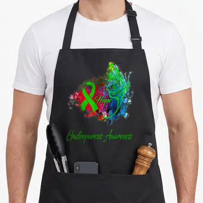 Cute gastroparesis awareness apron - Green butterfly and ribbon over multicolored watercolor splash with Hope — shown on a black cotton canvas apron against a white background