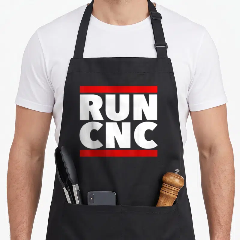 Run machinist apron - White RUN CNC text stacked between two red horizontal bars on grey background — shown on a black cotton canvas apron against a white background