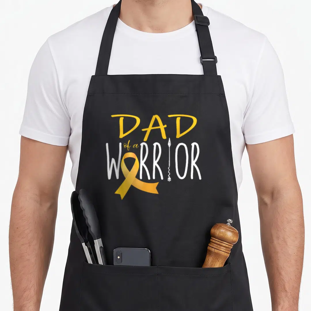 Warrior childhood cancer awareness apron - DAD of a WARRIOR text with yellow ribbon and white arrow on black apron — shown on a black cotton canvas apron against a white background