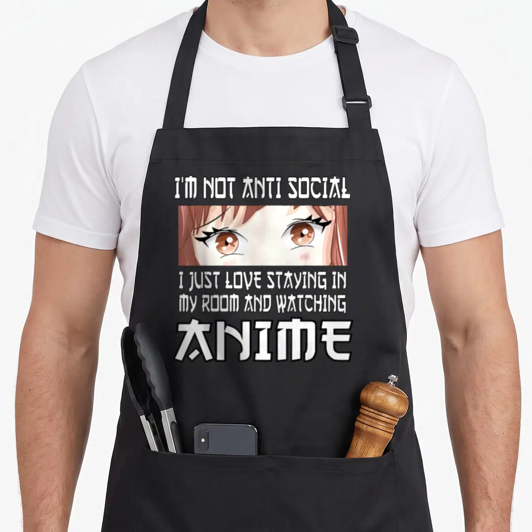 Watching anime apron - White text reading I'M NOT ANTI SOCIAL above brown anime girl eyes and three lines below ending — shown on a black cotton canvas apron against a white background