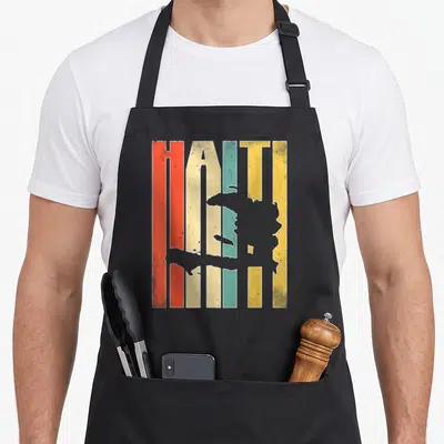 Funny haiti apron - Retro HAITI text in red orange beige teal yellow stripes with grey map silhouette overlay — shown on a black cotton canvas apron against a white background