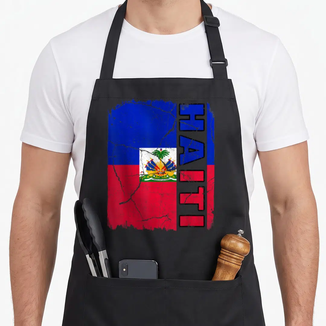 Haiti root pride apron - Distressed Haitian flag with vertical HAITI text in blue and red — shown on a black cotton canvas apron against a white background