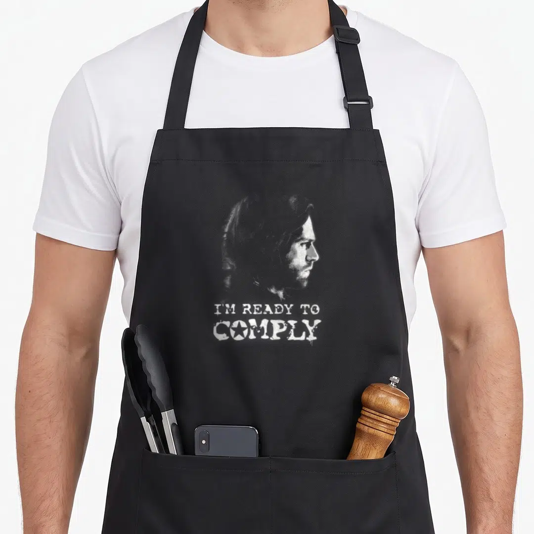 Civil winter apron - Distressed white male profile above 'I'M READY TO COMPLY' text with star in O — shown on a black cotton canvas apron against a white background