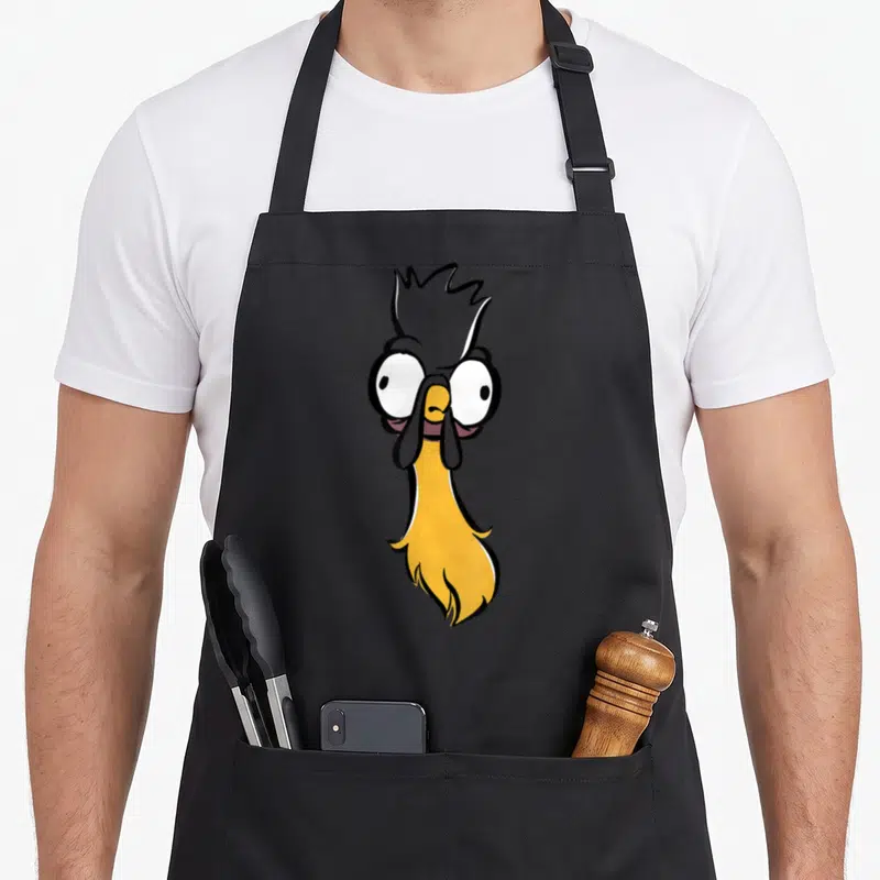 Hei face apron - Cartoon rooster head in yellow and grey with large white eyes on grey background — shown on a black cotton canvas apron against a white background