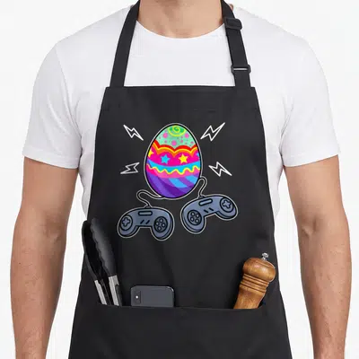 Gamer basket apron - Colorful easter egg with two game controllers and four white lightning bolts in cartoon style — shown on a black cotton canvas apron against a white background