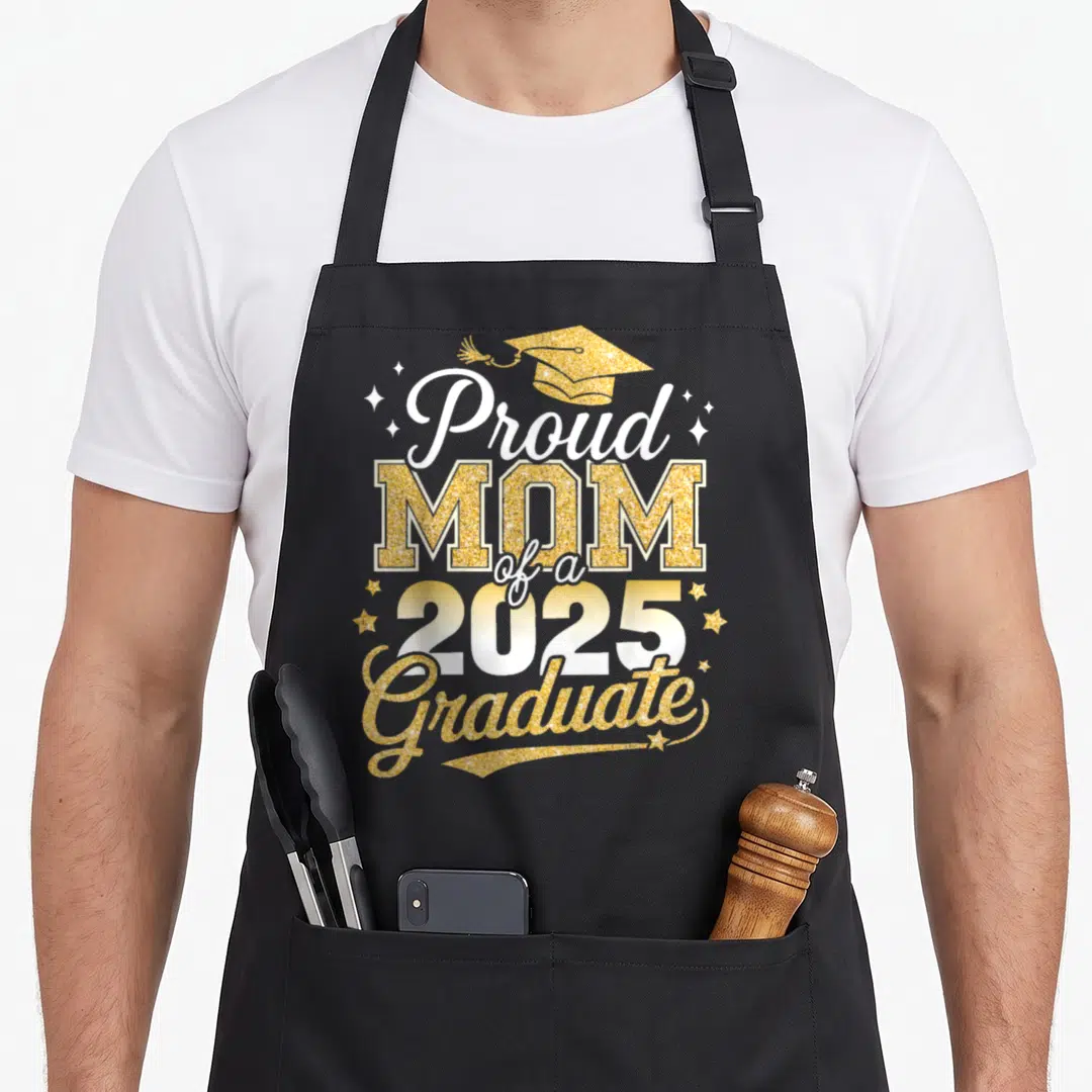 Proud diploma apron - Gold glitter Proud Mom of a 2025 Graduate text with graduation cap and stars — shown on a black cotton canvas apron against a white background
