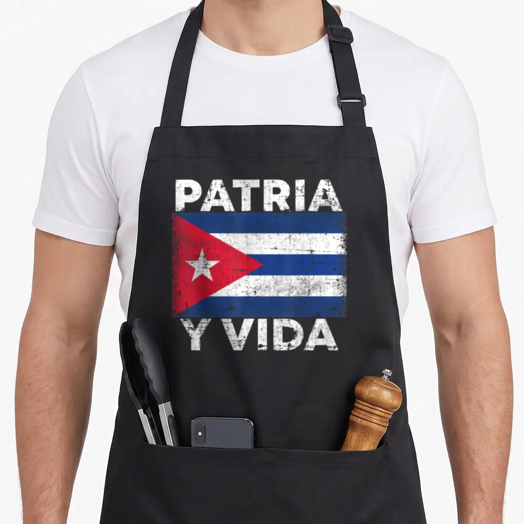 Patria cuban boy apron - Distressed Cuba flag with PATRIA above and Y VIDA below in white block letters — shown on a black cotton canvas apron against a white background