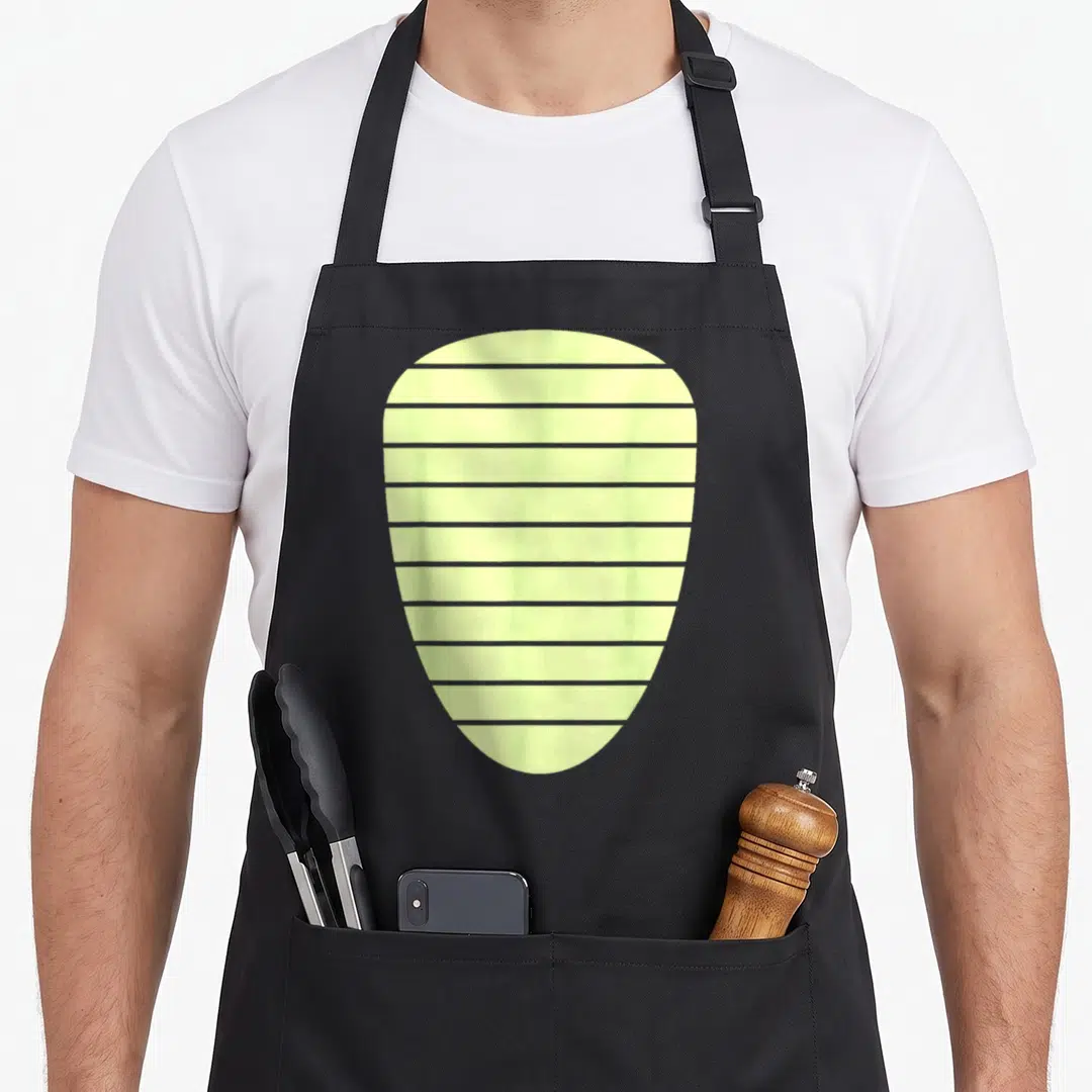 Alligator halloween apron - Pale yellow guitar pick with grey horizontal stripes on grey background — shown on a black cotton canvas apron against a white background
