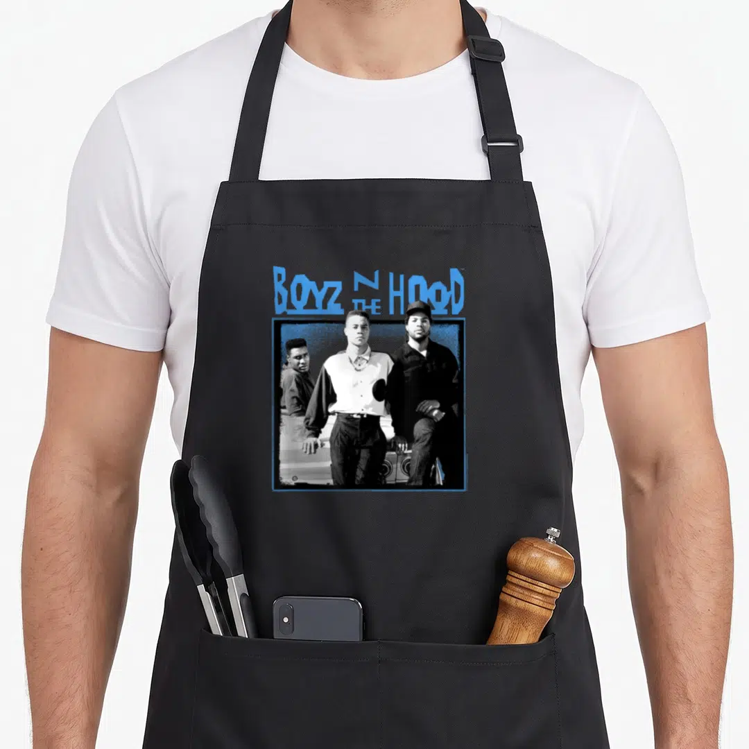 Boyz hood novelty apron - BOYZ N HOOD THE text above three men in a blue frame — shown on a black cotton canvas apron against a white background
