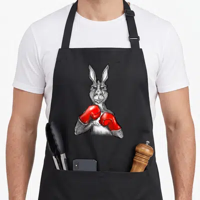 Boxing kangaroo apron - Realistic grey kangaroo illustration wearing bright red boxing gloves held up in a fighting — shown on a black cotton canvas apron against a white background