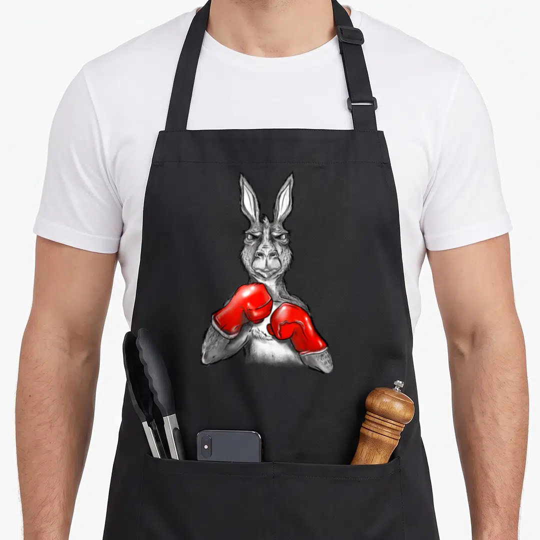 Boxing kangaroo apron - Realistic grey kangaroo illustration wearing bright red boxing gloves held up in a fighting — shown on a black cotton canvas apron against a white background