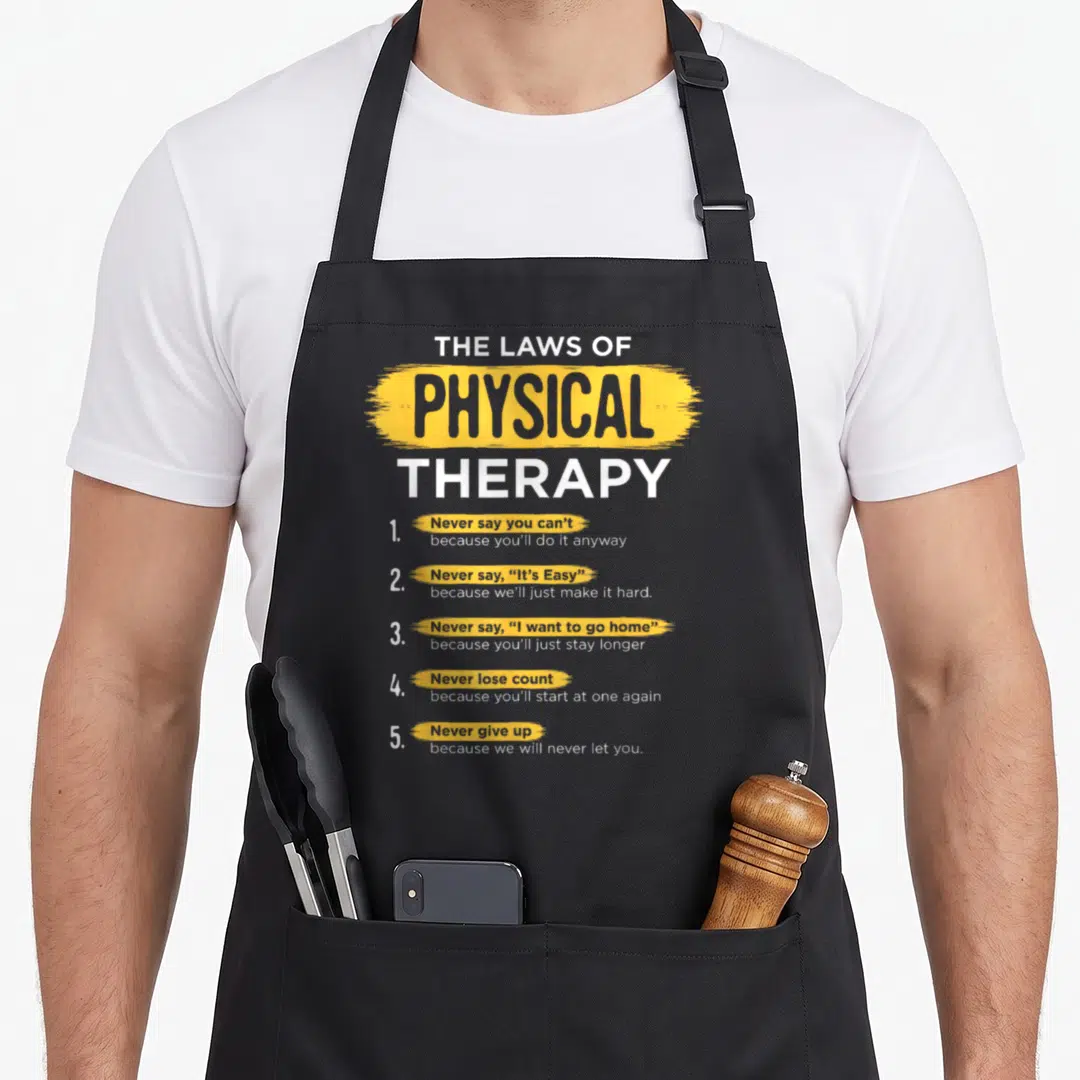 Physical therapist my therapy apron - The Laws of Physical Therapy text with yellow brush strokes and five numbered — shown on a black cotton canvas apron against a white background