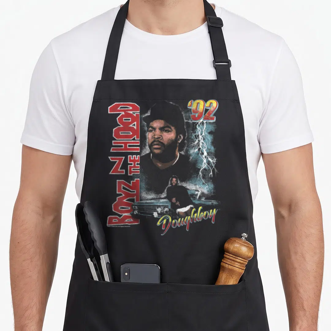 Boyz novelty apron - Retro poster art with man portrait, BOYZ N THE HOOD text, and Doughboy script — shown on a black cotton canvas apron against a white background