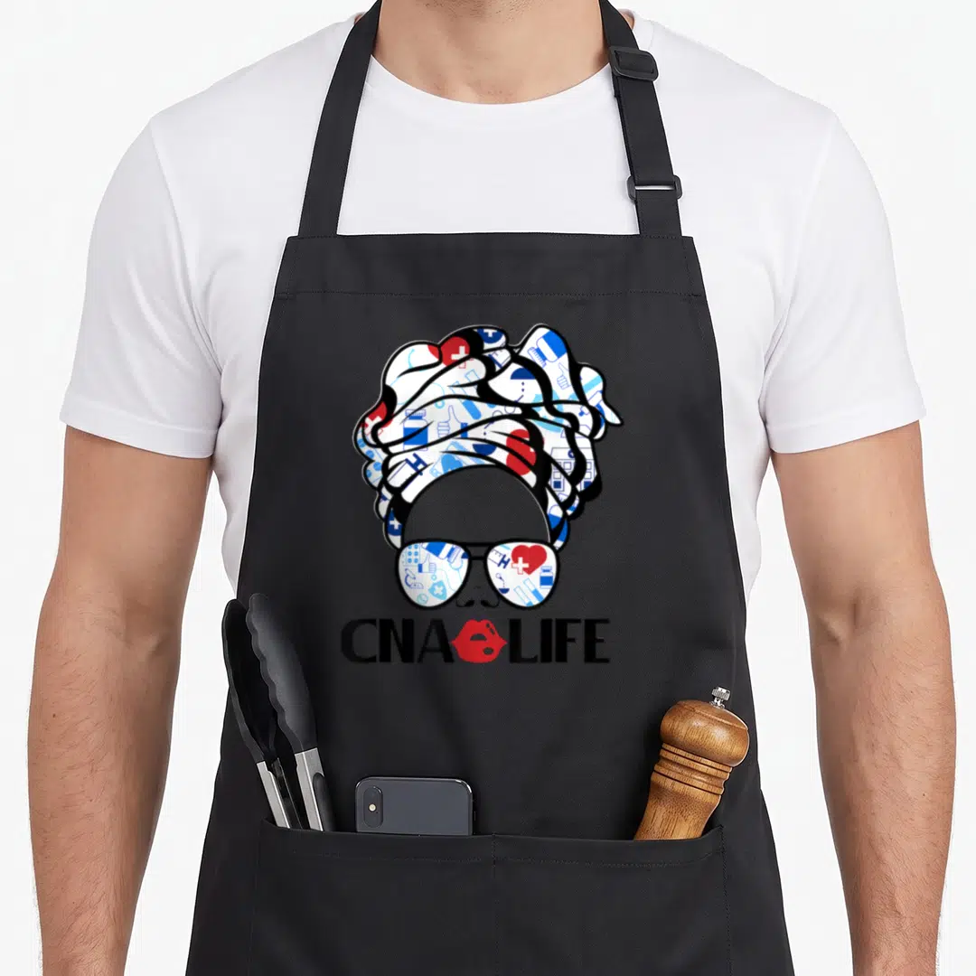 Cna night nurse apron - Cartoon woman with medical icon headwrap and CNA LIFE text with red lips — shown on a black cotton canvas apron against a white background