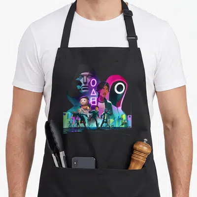 Unleashed squid apron - Cartoon collage of running characters and neon geometric symbols against a stylized city — shown on a black cotton canvas apron against a white background