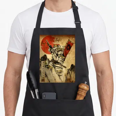 Galactic light apron - Samurai with rifle and flag, vertical Japanese text GINGAKYOUWAKOKU, red sun background — shown on a black cotton canvas apron against a white background
